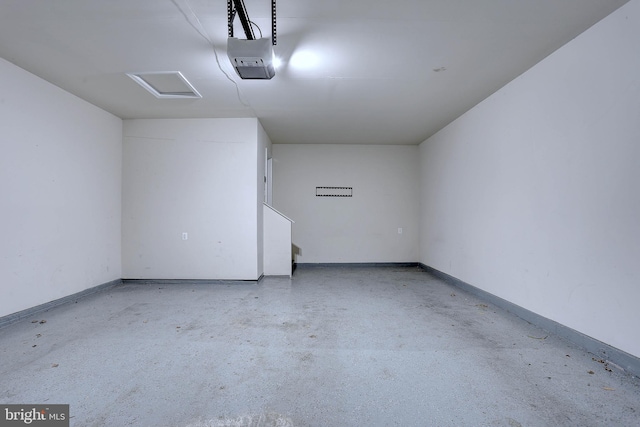 garage featuring a garage door opener and baseboards