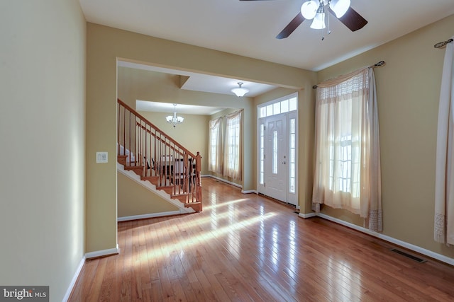 entrance foyer featuring hardwood / wood-style flooring, stairway, and plenty of natural light