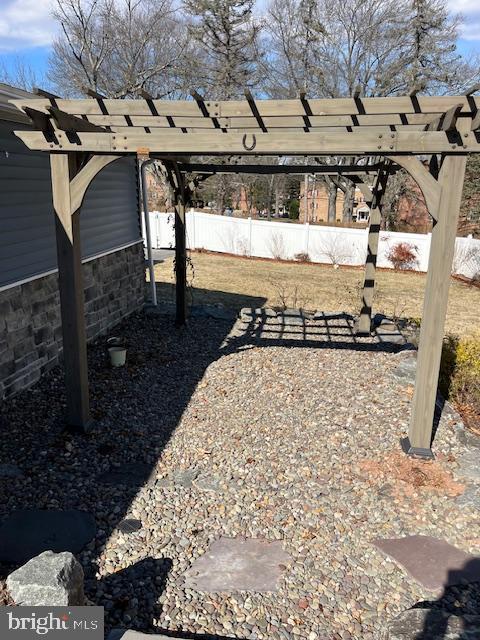 view of yard with fence and a pergola