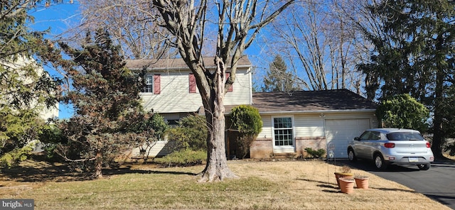 view of property exterior with driveway, brick siding, an attached garage, and a lawn