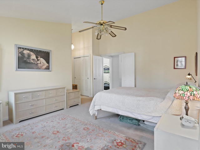 bedroom featuring a high ceiling, carpet, and ceiling fan