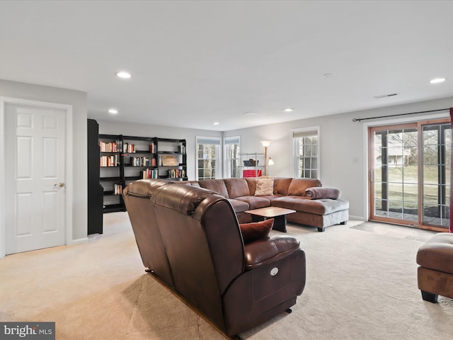 living room with light carpet, visible vents, recessed lighting, and baseboards