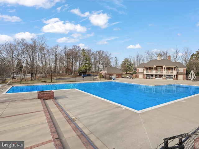 pool featuring a patio area and fence