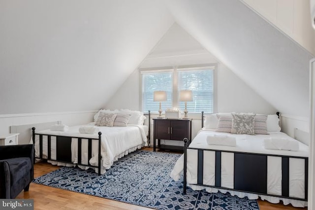 bedroom featuring lofted ceiling and wood finished floors