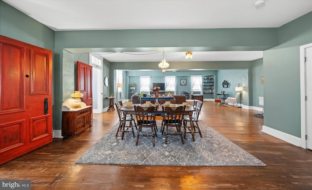 dining room with dark wood finished floors and baseboards