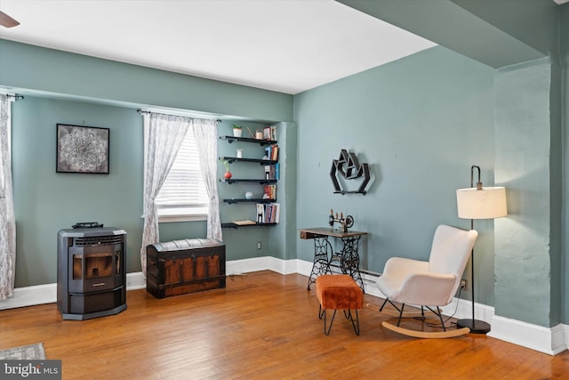 sitting room featuring baseboards and wood finished floors