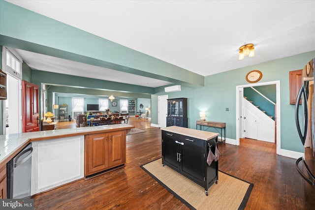 kitchen with tile countertops, stainless steel appliances, dark cabinetry, and dark wood-style flooring