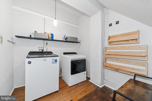 laundry room with baseboards, wood-type flooring, washing machine and dryer, and laundry area