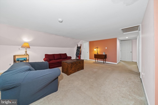 living room with lofted ceiling, attic access, carpet, and baseboards