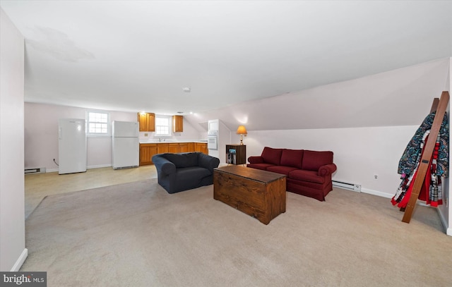 living room with baseboards, light carpet, baseboard heating, and vaulted ceiling