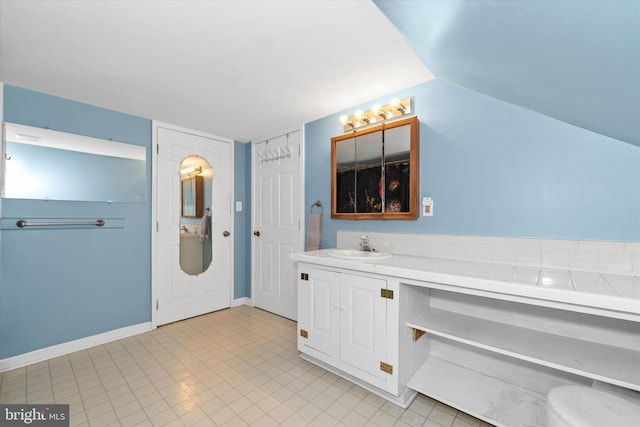 bathroom featuring vanity and baseboards