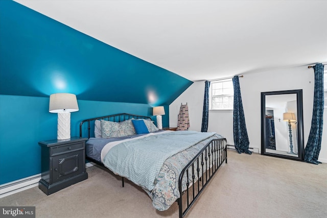 carpeted bedroom featuring a baseboard heating unit and lofted ceiling