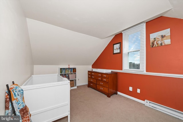 bedroom featuring a baseboard heating unit, lofted ceiling, baseboards, and carpet flooring