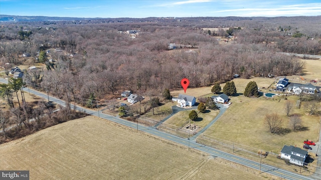 aerial view with a rural view and a wooded view