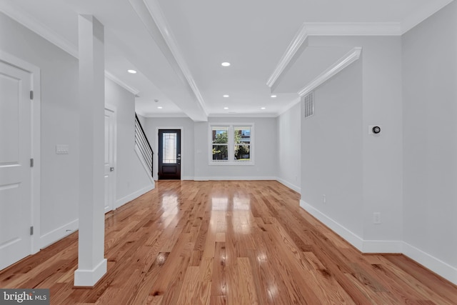 interior space with light wood finished floors, recessed lighting, crown molding, and baseboards