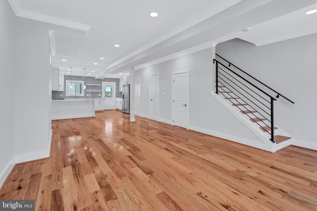 unfurnished living room with recessed lighting, stairway, ornamental molding, and light wood finished floors