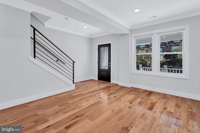 entryway with light wood-type flooring, ornamental molding, recessed lighting, stairway, and baseboards