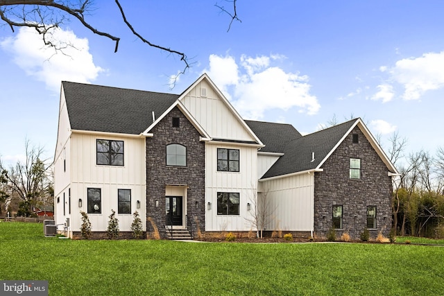 modern farmhouse style home with a front yard, central AC unit, board and batten siding, and roof with shingles