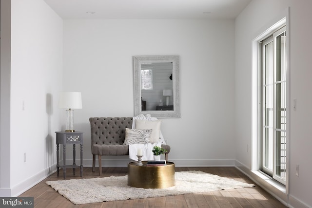 sitting room with a wealth of natural light, baseboards, and hardwood / wood-style floors