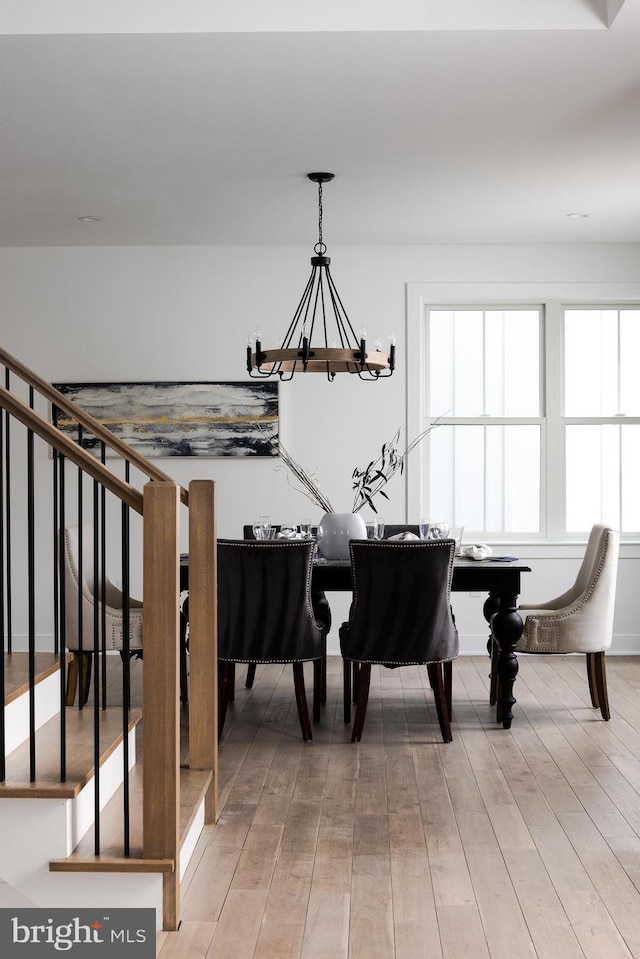 sitting room featuring light wood-style floors and an inviting chandelier