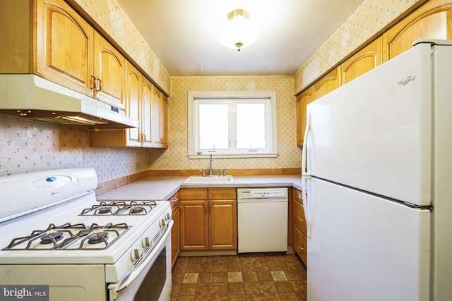 kitchen featuring wallpapered walls, white appliances, under cabinet range hood, and a sink