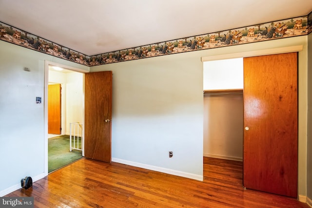 empty room featuring baseboards and wood finished floors