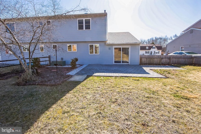 rear view of house with a yard, a patio, and fence