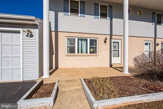 property entrance with brick siding