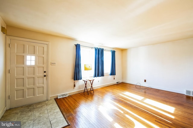 entryway featuring visible vents, baseboards, and hardwood / wood-style floors