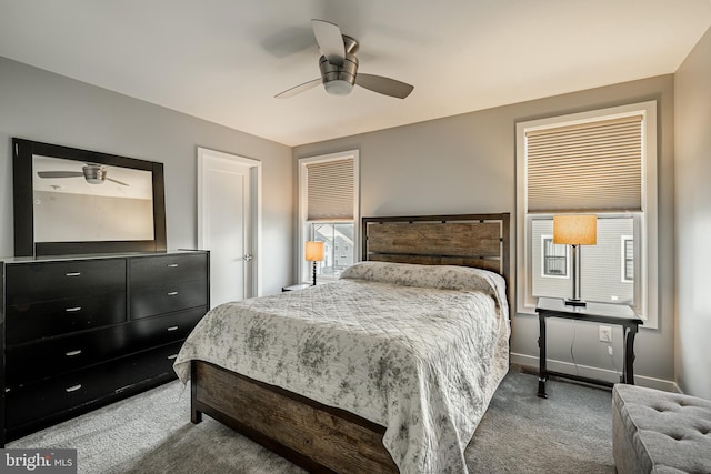 carpeted bedroom featuring baseboards and ceiling fan