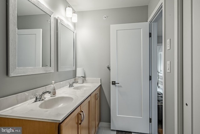 bathroom featuring a sink and double vanity