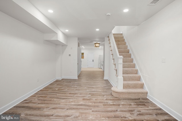 entrance foyer with light wood finished floors, visible vents, recessed lighting, and stairs