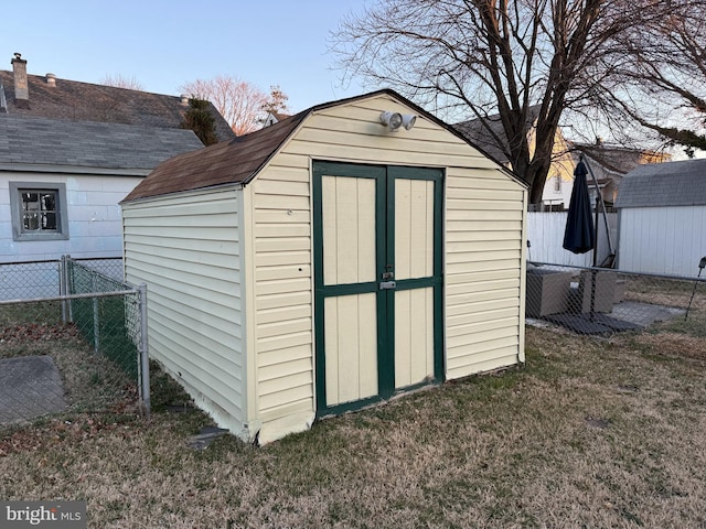 view of shed with fence