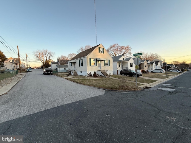 view of front of property featuring a residential view and a front lawn