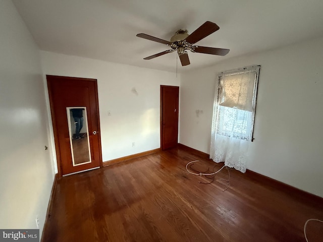 unfurnished room with ceiling fan, baseboards, and wood finished floors