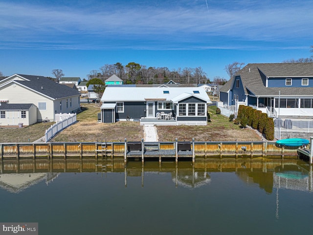 back of house featuring a residential view, a water view, and a fenced backyard