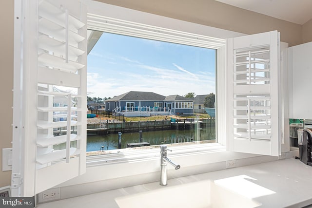 interior space with a water view and a sink