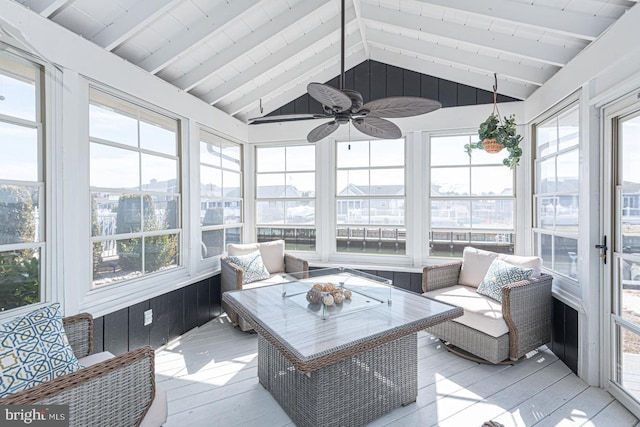 sunroom with lofted ceiling with beams, plenty of natural light, wooden ceiling, and a ceiling fan