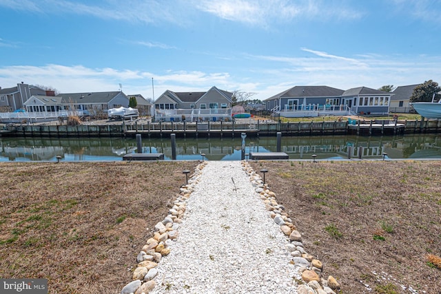 dock area with a residential view and a water view