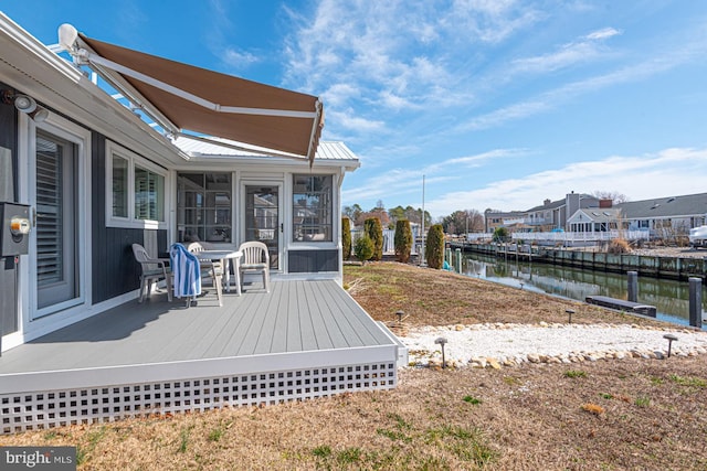 view of yard featuring a water view and a sunroom