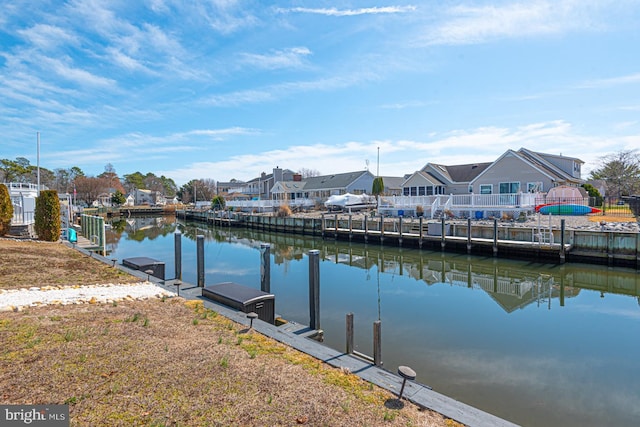 view of dock featuring a residential view and a water view