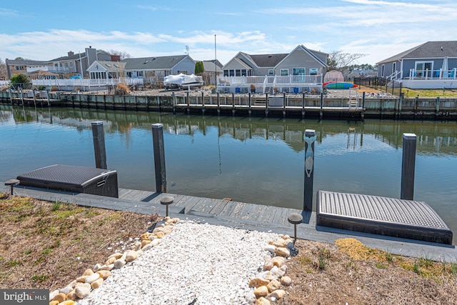 dock area with a residential view and a water view