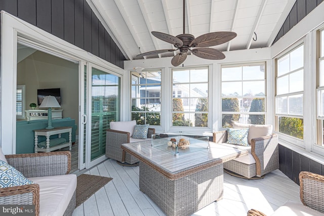 sunroom / solarium featuring vaulted ceiling with beams and a ceiling fan