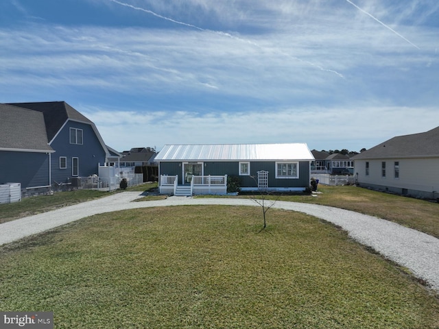 view of front of house featuring a residential view, a front yard, a porch, and driveway