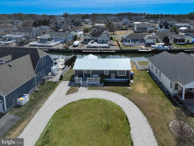 birds eye view of property with a residential view and a water view