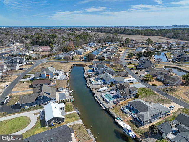 drone / aerial view with a residential view and a water view