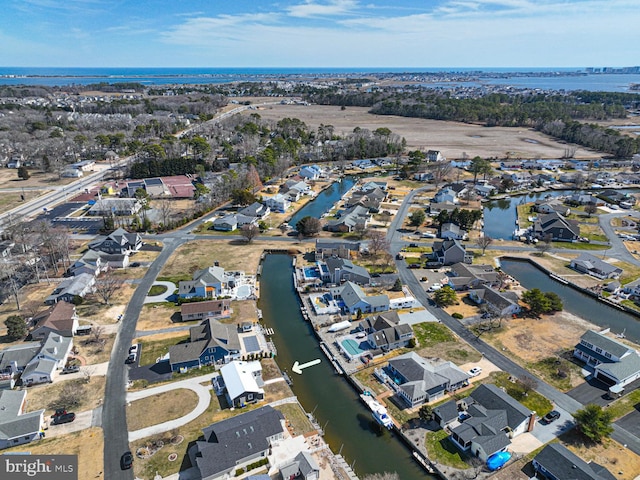 drone / aerial view featuring a residential view and a water view