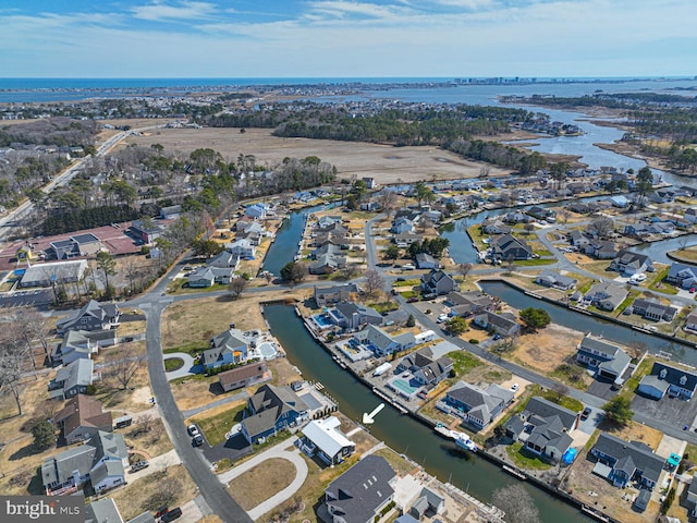 birds eye view of property with a residential view and a water view