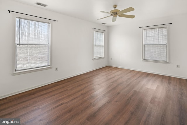 unfurnished room featuring visible vents, baseboards, a ceiling fan, and wood finished floors