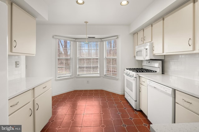 kitchen with tasteful backsplash, recessed lighting, and white appliances